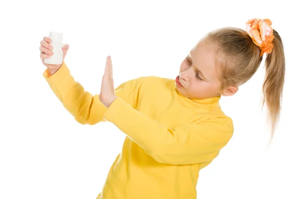 Cute girl denied medication in a bottle — Stock Photo, Image