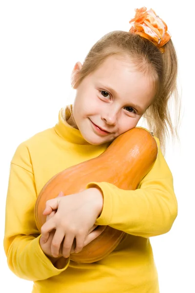 Cheerful girl hugs a pumpkin — Stock Photo, Image