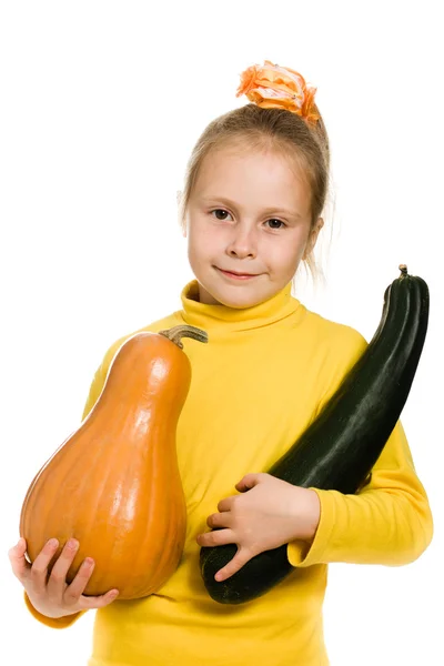 Cheerful girl holding a pumpkin and squash — Stock Photo, Image