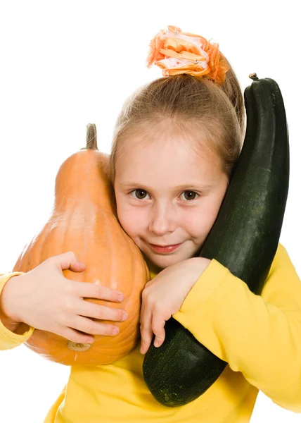 Cheerful girl holding a pumpkin and squash — Stock Photo, Image