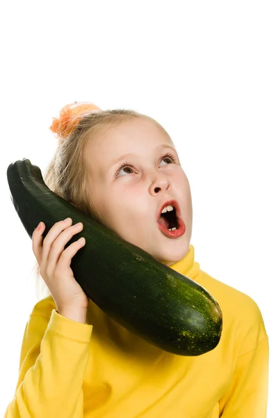 Cheerful girl talking on the zucchini — Stock Photo, Image