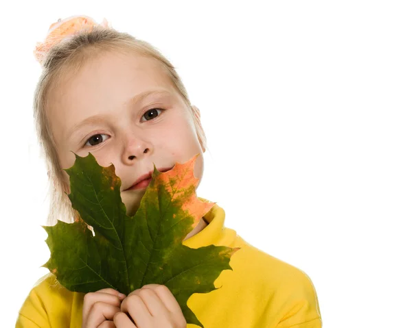 Shy girl with green maple leaf in his hand — Stock Photo, Image