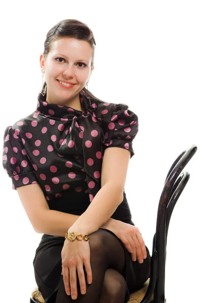 Beautiful woman in retro style sitting on a chair — Stock Photo, Image