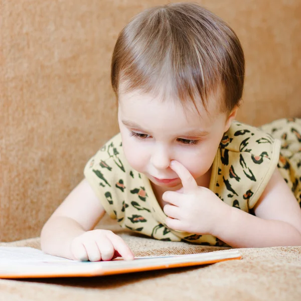 Beautiful cute baby reading a book — Stock Photo, Image