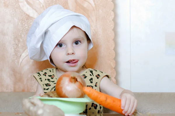 Beautiful cute little cook with vegetables — Stock Photo, Image