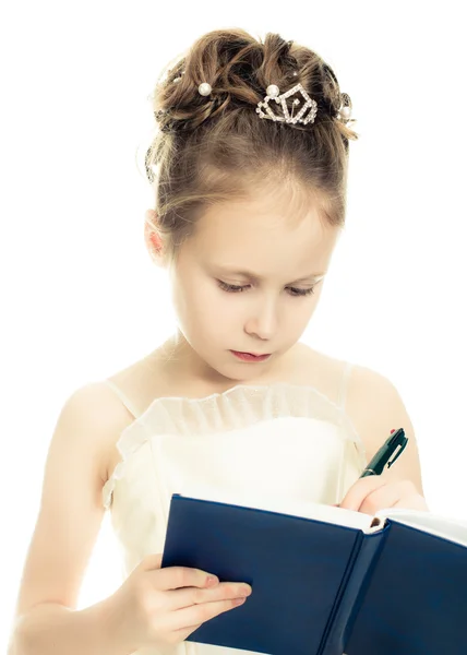 Pretty beautiful girl writing in a notebook . — Stock Photo, Image