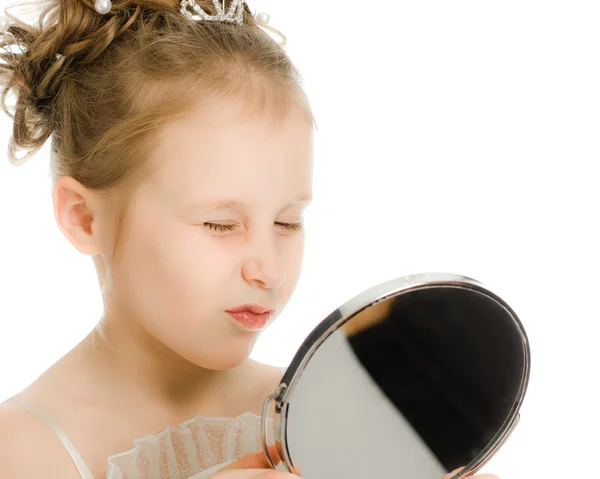 Pretty beautiful girl looks in the mirror. — Stock Photo, Image