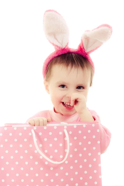 The little girl with pink ears bunny and bag. — Stock Photo, Image