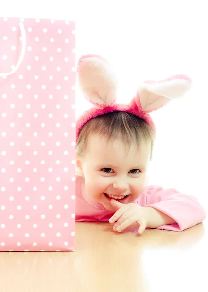The little girl with pink ears bunny and bag. — Stock Photo, Image