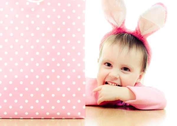 The little girl with pink ears bunny and bag. — Stock Photo, Image