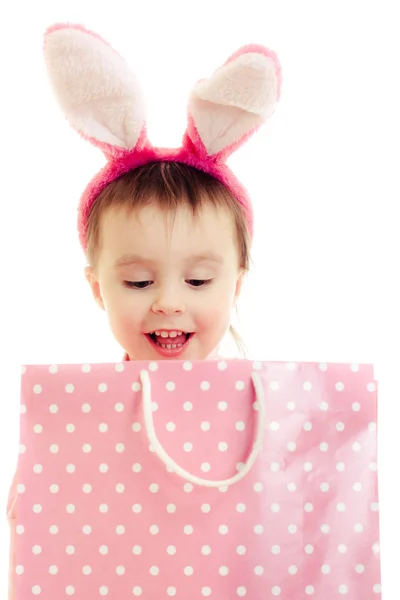 The little girl with pink ears bunny and bag. — Stock Photo, Image