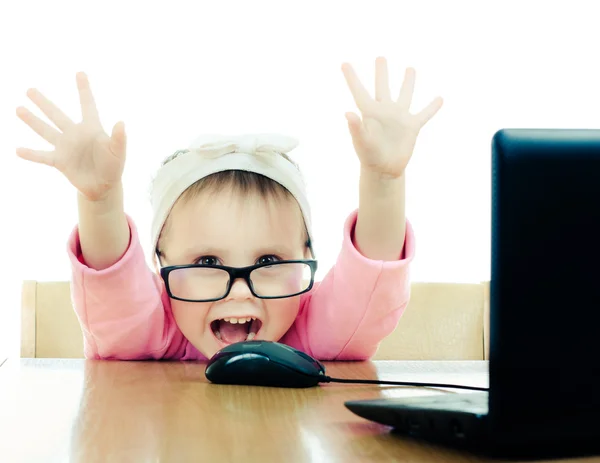 Cute baby with glasses looking into the laptop — Stock Photo, Image