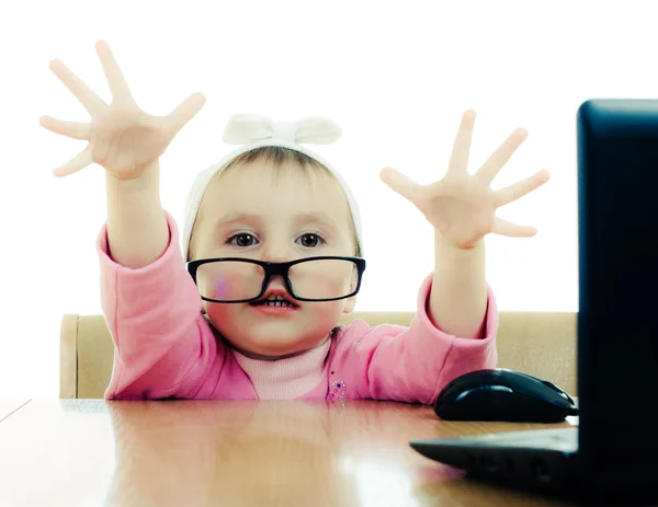 Cute baby with glasses looking into the laptop — Stock Photo, Image