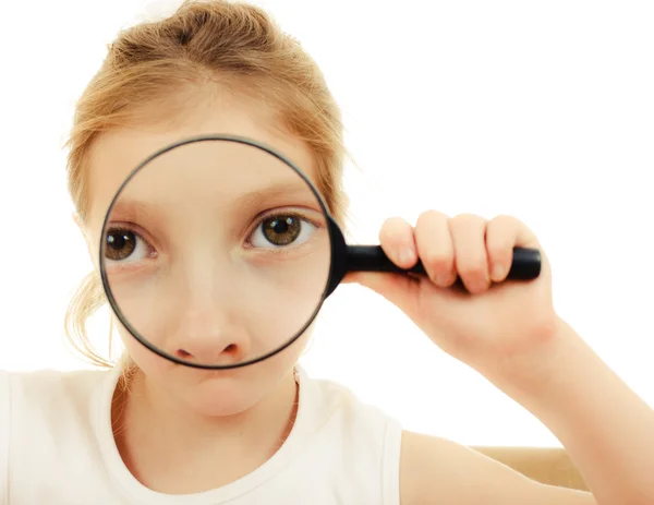 The girl looking through a magnifying glass. — Stock Photo, Image