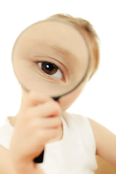 The girl looking through a magnifying glass. — Stock Photo, Image