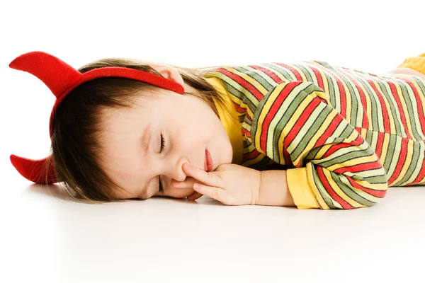 Baby with horns imp sleeps on the floor — Stock Photo, Image