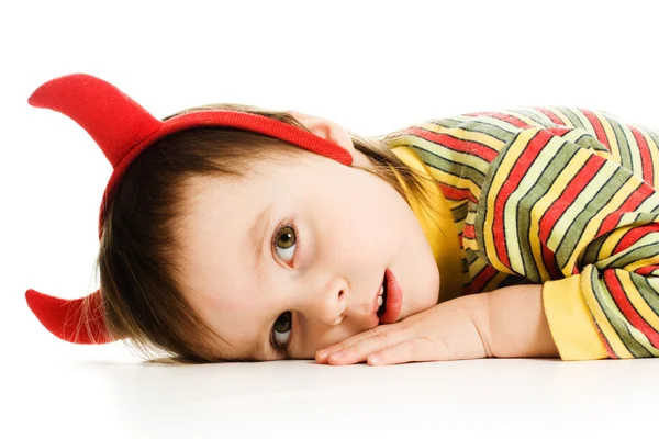 Baby with horns imp sleeps on the floor — Stock Photo, Image