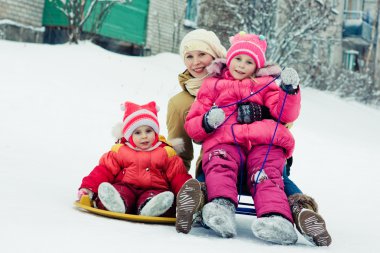 Mother with children on the sled. clipart