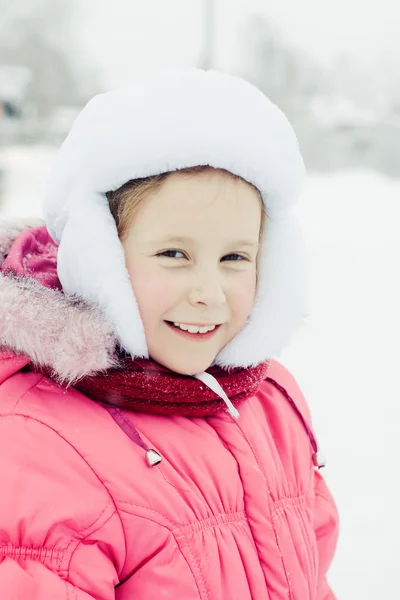 Beautiful happy girl in the red jacket. — Stock Photo, Image