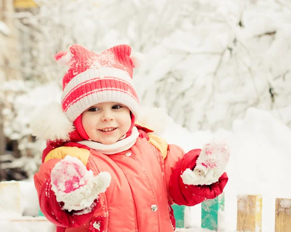 Beautiful happy kid in the red jacket — Stock Photo, Image