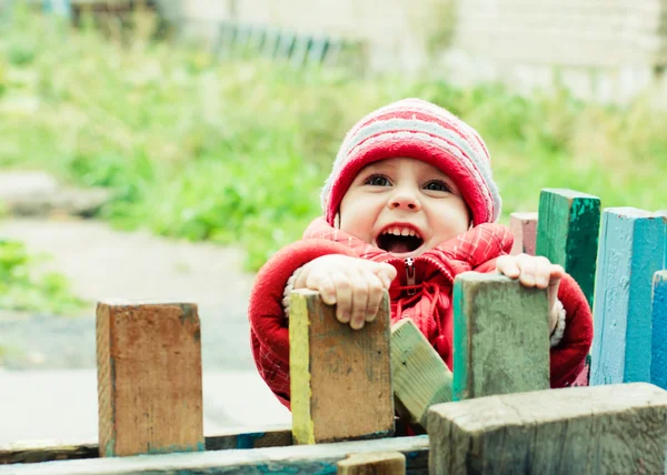 Beautiful happy kid in the red jacket — Stock Photo, Image