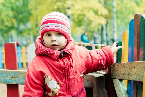 Beautiful happy kid in the red jacket — Stock Photo, Image