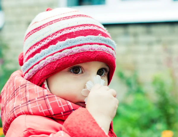 Beautiful happy kid in the red jacket — Stock Photo, Image