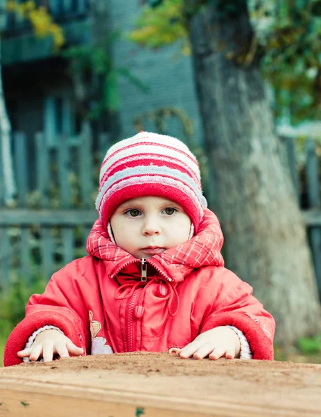 Beautiful happy kid in the red jacket — Stock Photo, Image