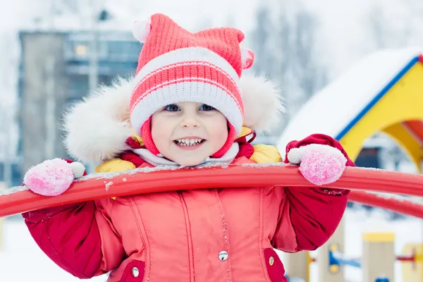 Beautiful happy kid in the red warm clothing. — Stock Photo, Image