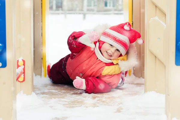 Beautiful happy kid in the red warm clothing. — Stock Photo, Image