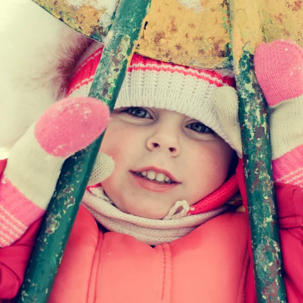 Beautiful happy kid in the red warm clothing — Stock Photo, Image