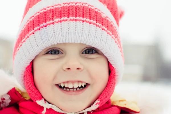 Beautiful happy kid in the red jacket — Stock Photo, Image