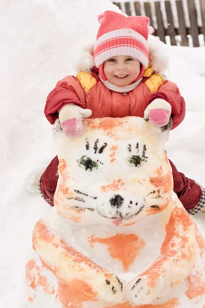 坐在一个雪人的快乐宝贝 — 图库照片