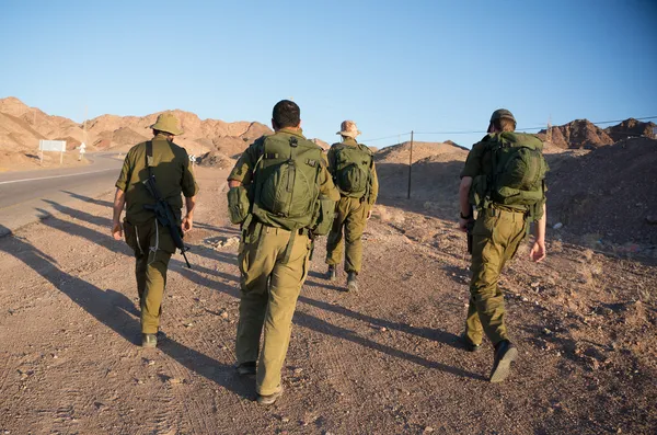 Soldiers patrol in desert — Stock Photo, Image