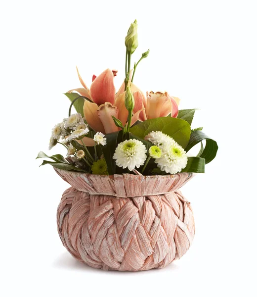 Spring flowers in wicker vase isolated — Stock Photo, Image