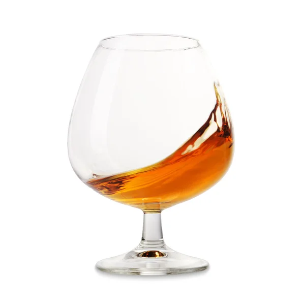 Cognac splashes in a glass — Stock Photo, Image