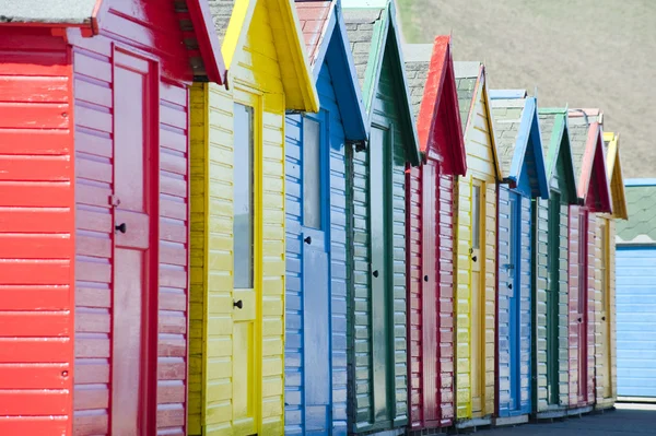 Row of colorful wooden beach huts — Stock Photo, Image