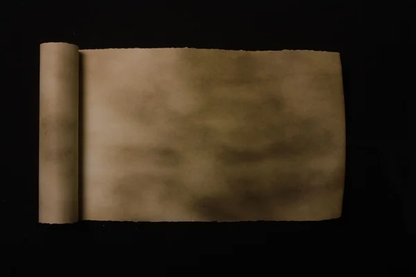 검은 배경에 고립 된 종이의 오래 된 롤 — 스톡 사진