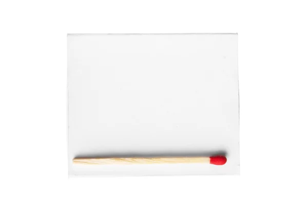 Red match on a white box isolated on a white background. — Stock Photo, Image