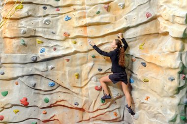 young business woman on rock wall clipart