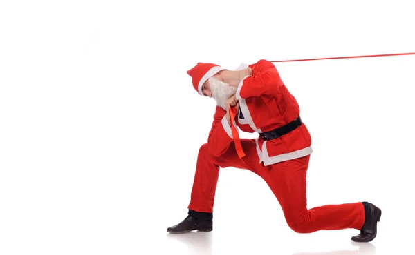 Santa Claus pull red ribbon — Stock Photo, Image