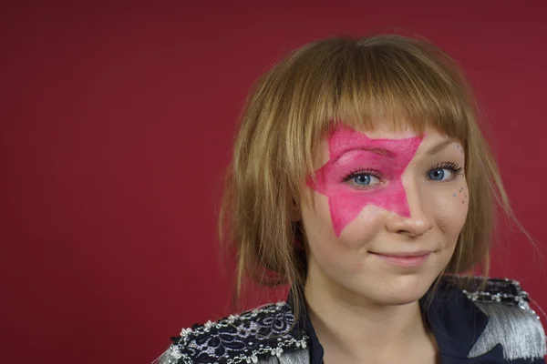 Adolescente con estrella rosa en la cara —  Fotos de Stock
