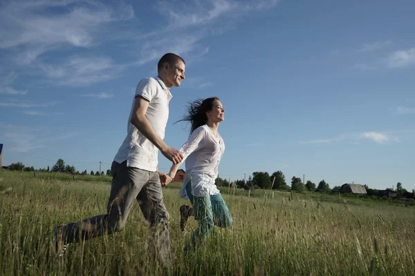 Couple marchant à travers le champ — Photo