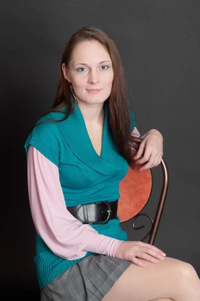 Girl sitting on a chair — Stock Photo, Image