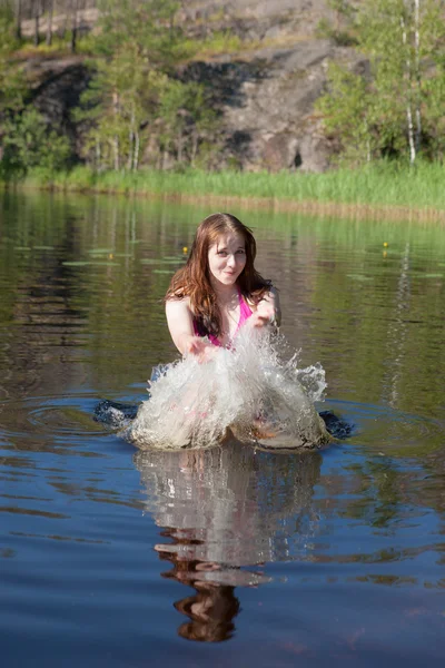 Teenage girl plays with water — Stock Photo, Image