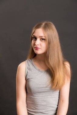 Siyah arka planda uzun saçlı bir kızın stüdyo portresi.