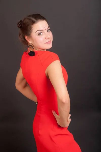 黒い背景をした赤いドレスの細い女の子 — ストック写真