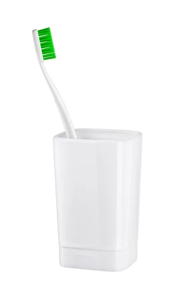 Tandborste i glas på en vit bakgrund — Stockfoto