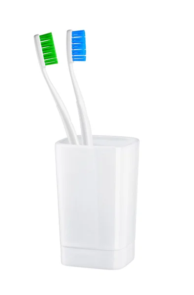 Tandenborstels in glas op een witte achtergrond — Stockfoto