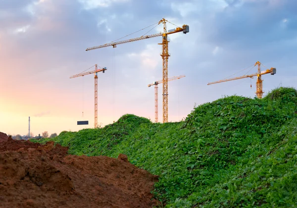 Construction site. Industrial landscape with cranes and pipe. — Stock Photo, Image